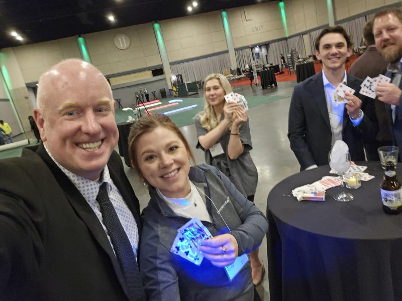 Trade show magician drawing a crowd at a corporate booth