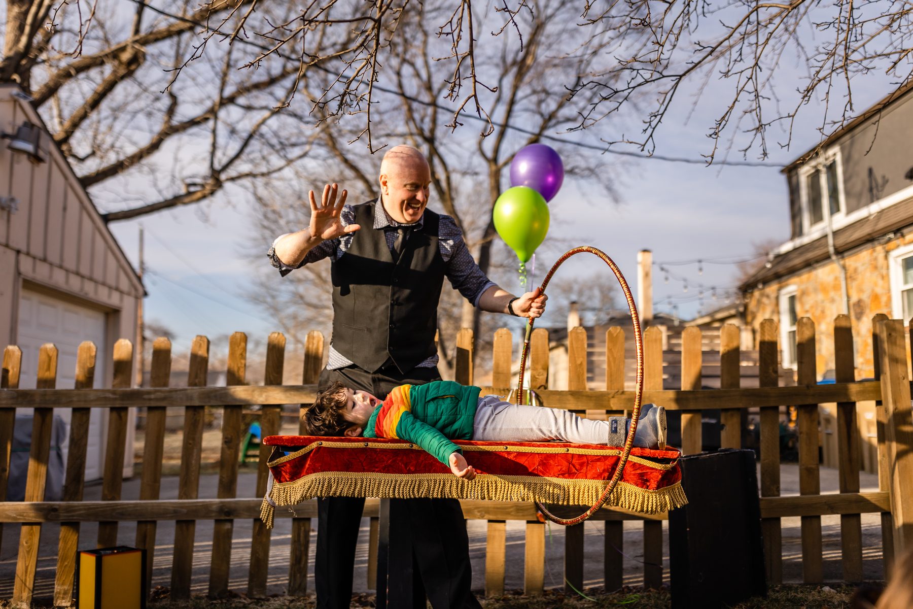 A backyard birthday, a levitation, balloons holding their breath.