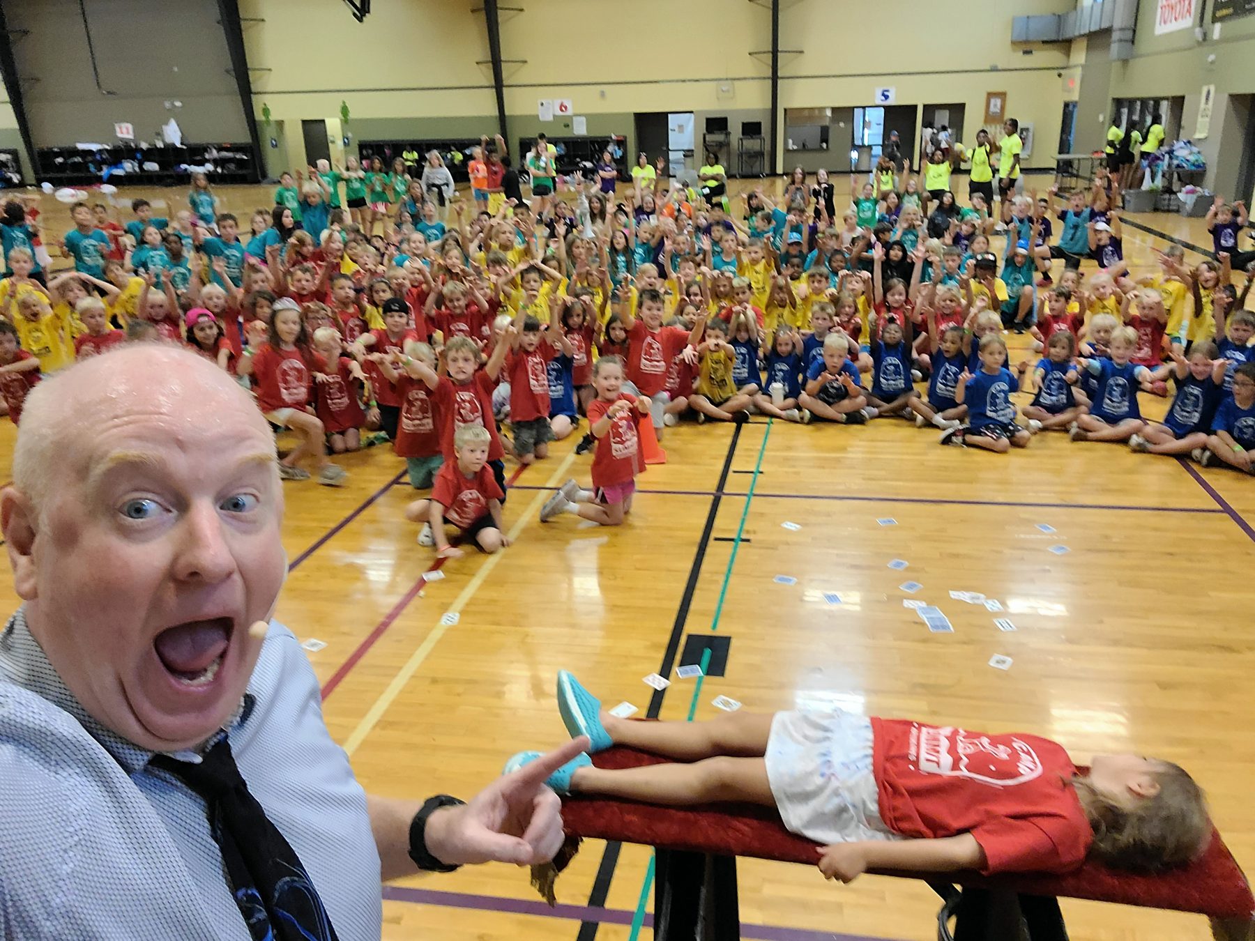A summer camp, hundreds of color-coded shirts, a volunteer suspended in disbelief.